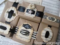 some brown boxes with black and white designs on them are sitting on sheet music paper