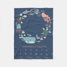 a blue towel with an image of animals and sea creatures on it, in the shape of a wreath