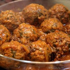 some meatballs are being cooked in a pot