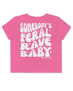 Unleash your wild side with the 'Somebody's Feral Rave Baby' Crop Tee, the perfect piece for those who bring the untamed energy of a first-timer to every event. With a playful declaration on the back and a bold tagline on the front, this tee is for the spirited raver who's always ready to dance like nobody's watching. Composed of a dynamic 95% polyester and 5% elastane mix, this crop tee offers flexibility for all your rave moves. The fabric is a premium knit mid-weight jersey, ideal for both its softness and durability. With its four-way stretch fabric, the tee moves with you, keeping its shape from dusk till dawn. The regular fit of this tee makes it a versatile piece for pairing with any rave attire, from classic denim to flashy bottoms. This crop tee is a made-to-order symbol of your l Fitted Graphic Print Top For Music Festival, Trendy Custom Print Tops For Concert, Fitted Pink Top For Music Festival, Trendy Pink Tops For Festival, Fitted Funny Print Band Merch Tops, Fitted Fun Festival Tops, Fitted Fun Tops For Festival, Fun Fitted Tops For Festivals, Fitted Text Print Top For Concert