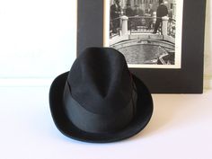 Vintage men's Italian hat with a feather, Finissimo black hat in 6 7/8 size; it feels very soft and luxurious. It is in very good vintage condition, with few minor flea bites along the back rim. Thank you for stopping by! Black Fitted Flat Cap Felt Hat, Classic Black Flat Cap Felt Hat, Black Formal Short Brim Hat, Formal Black Short Brim Hat, Italian Hat, Black Hat, May 17, Chicago Il, Vintage Men