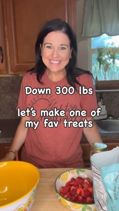 a woman sitting in front of a bowl of strawberries with the words down 300lbs let's make one of my fav treats