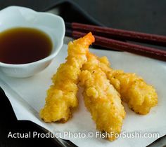 some food is sitting on a plate with chopsticks next to it and a cup of tea