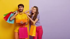 a man and woman are holding shopping bags