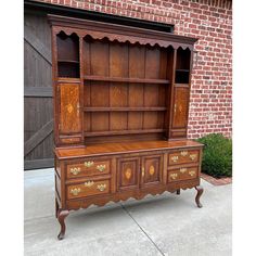 an old wooden dresser sitting on top of a sidewalk