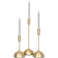 two brass candlesticks with white candles on them