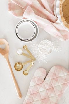 baking supplies laid out on top of a white table with utensils and spoons