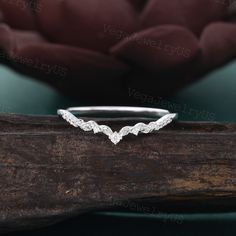 a white gold wedding band with three wavy leaves on the side, set in 18k white gold