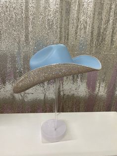 We created our denim & rhinestones collection to wear with your bell bottoms, denim dresses and jumpsuits, and cowgirl boots. Perfect for that Nashville trip or to complete your denim outfit! This hat features: Light blue straw hat Crystal rhinestones on the underneath brim Matching crystal hat band Sizing: This hat is a one size fits all! The band on the inside is a stretchy band; all orders come with a custom Rhinestone Cowgirl dust bag and foam pieces that can be stuck behind the hat band to Denim Cowgirl Hat, Trendy Blue Hat For Rodeo, Blue Western Hat For Rodeo, Fitted Blue Hat For Rodeo, Custom Blue Hats For Rodeo, Blue Rhinestone Hat For Summer, Blue Summer Hat With Rhinestones, Custom Blue Rodeo Hat, Denim Cowboy Hat