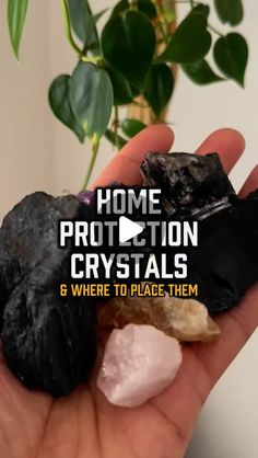 a person holding some rocks in their hand with the words home protection crystals and where to place them