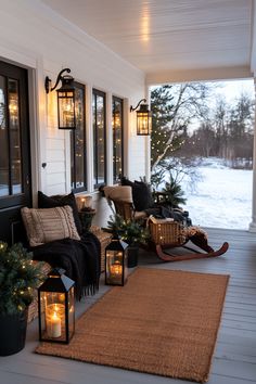 a porch decorated for christmas with lanterns and lights