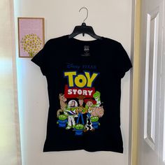 Disney Toy Story T-Shirt Never Worn Size M- Smaller Fit 100%Cotton Black Disney T-shirt For Disney Trips, Black Pre-shrunk T-shirt For Disney Trips, Black Themed T-shirt For Disney Trips, Graphic Tee For Disney Trips In Black, Black Graphic Tee For Disney Trips, Black T-shirt With Letter Print For Disney Trips, Black Graphic Print Top For Disney Trips, Black Graphic Print Tops For Disney Trips, Themed Black T-shirt For Disney Fan Events