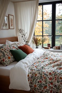 a bed sitting in front of a large window