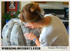 a woman is working on a sculpture in her living room with the caption'working on first layer '