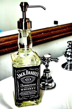 a bottle of jack daniels whiskey sitting on top of a sink