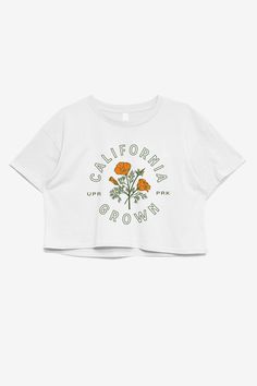 From hot deserts to dense forests, and from snowy mountains to ocean views, California has it all. Decorated with the iconic California poppy, this crop tee is one of our most poppy-ular pieces. Made from high quality mid-weight cotton, this shirt is for California locals and visitors alike. The California Collection Clothing and provisions inspired by the Golden State. California's stretch of land is vast and bountiful. Just when we think we'd seen it all, there's more around the corner. This c Hot Desert, California Shirt, California Outfits, Diy Wax, We Are All Human, Paint Line, California Poppy, Crop Tee, Clothes Collection