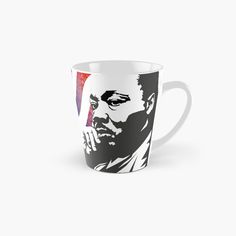 a tall mug with the face of a man on it