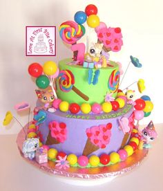 a birthday cake decorated with candy and lollipops