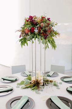 the table is set with plates and place settings