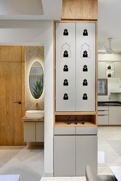 a modern kitchen with wooden cabinets and white walls