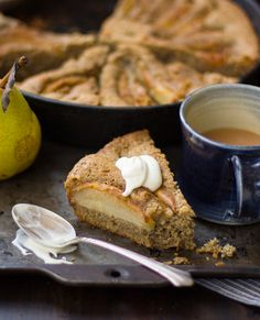 there is a piece of pie and a cup of tea on the tray next to it