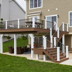 an apartment building with stairs leading up to the front door and second story balcony area