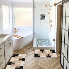 a bathroom with wood flooring and white bathtub next to a walk in shower