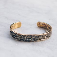 Brass Abstract Band Bracelet that is slightly adjustable. Available in women's and men's lengths. A rustic gold cuff bracelet style adds the perfect touch dressed up or down. Bracelet Size Medium (Women's) Large (Men's) Available in 925 Sterling Silver https://etsy.me/3i4Htje A note about brass jewelry and oxidization: Verdigris is the common name for a green coloring obtained through the application of acetic acid to copper plates or the natural patina formed when copper, brass or bronze is wea Adjustable Gold Etched Bangle, Adjustable Gold Band Cuff Bracelet, Adjustable Etched Gold Bangle, Adjustable Etched Gold Cuff Bracelet, Adjustable Etched Bronze Cuff Bracelet, Adjustable Bronze Etched Cuff Bracelet, Adjustable Etched Bronze Bracelets, Adjustable Etched Brass Cuff Bracelet, Adjustable Brass Etched Cuff Bracelet