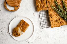 slices of bread sitting on top of a white plate next to a wooden spatula