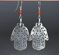 "Beautiful ethnic earrings composed of two antique hand of Fatima silver pendants and two Mediterranean coral beads. The pendants measure 2.28 inches (5.8 cm), while the total height of the earrings is 3.54 inches (9 cm). Provenience: Tunisia. Weight: 10.1 g CAD1. Back to \"Earrings\" section: https://www.etsy.com/shop/ArteOrientaleBologna?ref=l2-shopheader-name%C2%A7ion_id&section_id=18709850 Back to my shop: https://www.etsy.com/shop/ArteOrientaleBologna?ref=hdr_shop_menu" Etruscan Jewelry Earrings, Handmade Coral Bohemian Earrings, Coral Ganesh Pendant, Hand-strung Red Coral Jewelry, Artisan Red Coral Hand-strung Jewelry, Hand Of Fatima, Ethnic Earrings, Christian Cross, Coral Beads