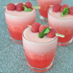 raspberry mojits with mint garnish on the rim are ready to be served