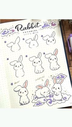 an open notebook with drawings of rabbits on it