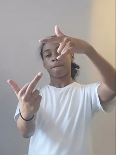 a girl making the peace sign with her hands