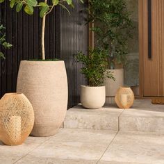 three planters sitting on the ground next to each other