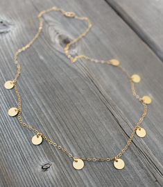 "Sparkly 14K gold filled chain with nine little discs. Incredibly delicate and sits effortlessly perfect. Perfect any-day any-time necklace. Works great for dressing up or dressing down. I found pictures of Mimi Ikonn wearing a similar necklace - gorgeous! Please select length from the drop down menu. My model is wearing an 18\" necklace, Mimi is wearing a 16\" necklace. 14\" and 15\" would be choker length. C O M P O N E N T S: Chain - 14k gold filled Discs - 6mm in diameter, matte gold plated Dainty 14k Gold Filled Coin Necklace, Mimi Ikonn, Embossed Jewelry, Talisman Jewelry, Gold Coin Necklace, Soldering Jewelry, Silver Eagles, Gold Coin, Coin Necklace