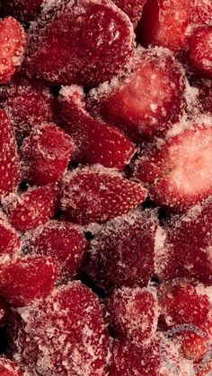 strawberries covered in powdered sugar and sitting on top of each other with one bite taken out