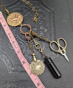 a pair of scissors and some other items are on a table next to a ruler