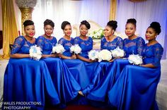 the bridesmaids are posing in their blue dresses