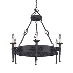 an iron chandelier with five candles hanging from the bottom and four lights on each end