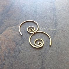 Small 14k gold filled spiral hoop earrings. Petite AND make a statement: win- win! Formed and cold forged from 20 gauge 14k gold filled wire into this small coil. The ends have been sanded for comfort in wearing, then polished to a light shine. * Small spiral hoop earrings are approximately 17mm in diameter. Please see measurement photo. You can also choose sterling silver at the dropdown to the right. If you are looking for the larger version of this style click here: https://www.etsy.com/listi Gold Spiral Wire Wrapped Hoop Earrings, Unique Spiral Hoop Earrings Gift, Minimalist Spiral Hoop Earrings Handmade, Handmade Minimalist Spiral Hoop Earrings, Minimalist Handmade Spiral Hoop Earrings, Gold Minimalist Spiral Wrap Earrings, Minimalist Gold Spiral Wrap Earrings, Swirl Shaped Nickel-free Hoop Earrings As Gift, Swirl Hoop Earrings Nickel Free Gift