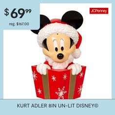 a mickey mouse figurine sitting on top of a red box with snowflakes