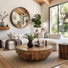 a living room filled with furniture and a large mirror on the wall above it's windows