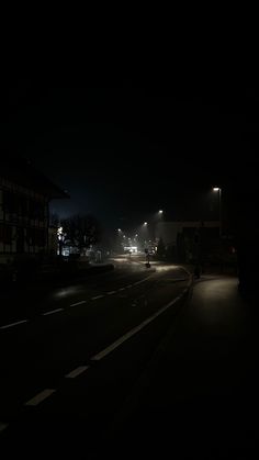 an empty street at night in the dark