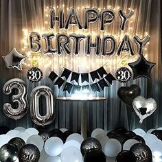 a birthday party with balloons and streamers in the shape of 30, fifty and thirty