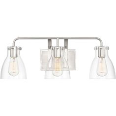 three light bathroom fixture with clear glass shades on the sides and an adjustable metal arm