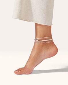 Build a modern anklet stack by pairing minimalist Dane, slinky Zeina and light-catching Lumi. The Modern Stack is water-durable so you can wear it with ease in water. Finished in high-polish silver. Note: Please indicate your preferred size in Dane. This item is final sale. Discount codes and other offers cannot be used on this product. platinum-plated steelfinish: high polishdane - tension closurezeina and lumi - lobster clasp product measurements:dane anklet - 9"length/circumference: 9 1/16”wi Silver Flexible Anklets For Summer, Silver Minimalist Anklets For Party, Adjustable Silver Ankle Wrap Anklet, Elegant Flexible Silver Anklets, Elegant Silver Ankle Wrap Jewelry, Anklet Stack, 14k Gold Ear Cuff, Jenny Bird, Gift Inspo