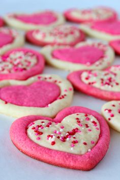 pink and white heart shaped cookies with sprinkles