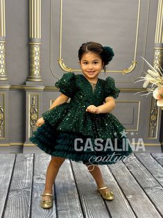 The Serena Dress is not just an outfit; it's a source of boundless excitement for your little one. Crafted for baby girls, this enchanting dress combines playful elegance and sophisticated charm, ensuring your child stands out on every occasion. In a mesmerizing Emerald Green hue, the Serena Dress captivates with its knee-length silhouette and layers of cascading ruffles, creating a voluminous and whimsical look. The chest area is adorned with a delightful bow, adding a touch of sweetness to the overall design. The fabric of the dress is a radiant, glittering material that catches the light, providing a dazzling and luminous quality. The short sleeves offer comfort and freedom of movement, allowing your child to dance, play, and twirl with ease. The dress is not just an outfit; it's a stat Serena Dress, Fluffy Dress, Dress Knee Length, Dress For Girls, Dress Picture, Toddler Dress, Little Princess, Formal Wear, Baby Dress