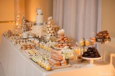 a table topped with lots of desserts and pastries