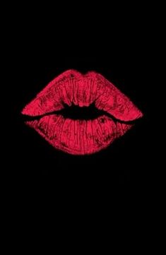 red lipstick on black background with the light reflecting off it's lip and mouth